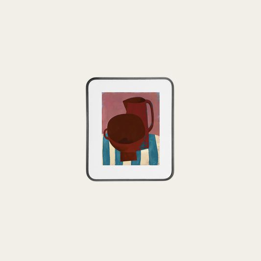 Framed artwork of a red pitcher on a striped surface with a white background