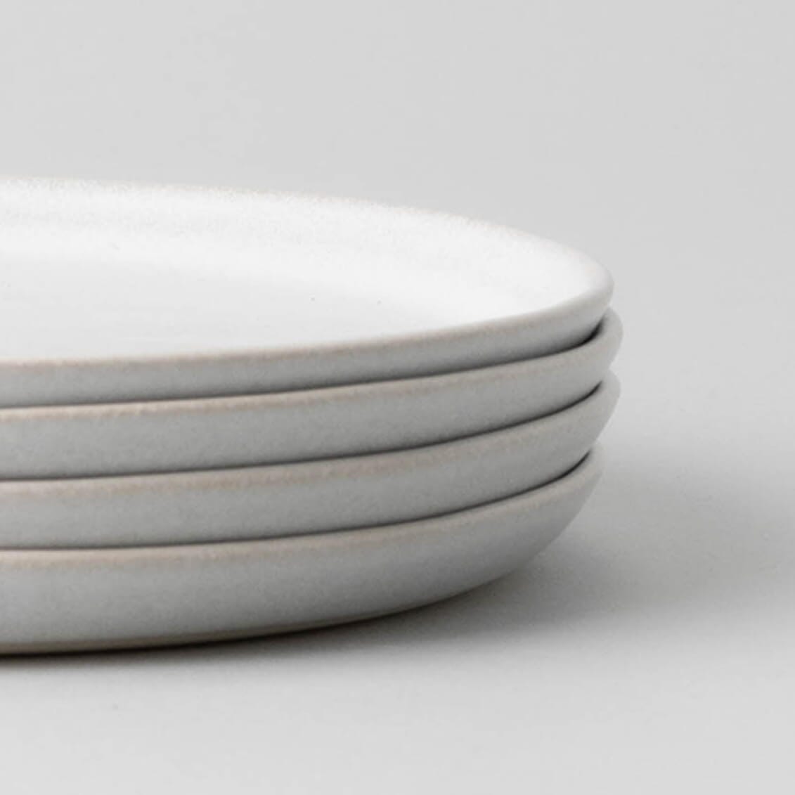 Salad plates dinnerware by Fable Home, shown in a stoneblue finish, . – #stoneblueide view